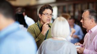 Man listening to small group of people.