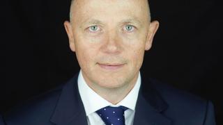 Giles Cunningham in a suit.