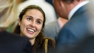 Woman smiling at a man in a suit.