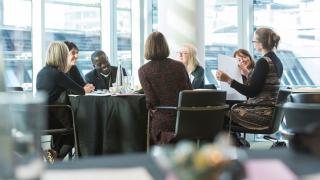 Group of colleagues at a table talking.