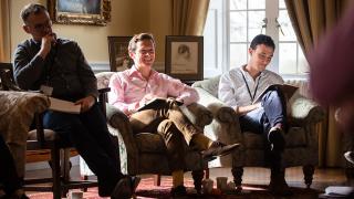 Men sat in chairs during a working group.