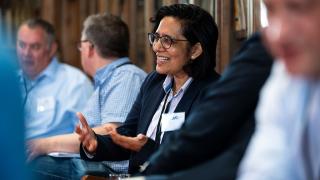 Woman talking to two men.