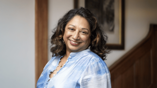 lady in blue smiling at camera