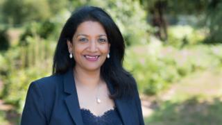 Vijaya, smiling outside
