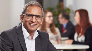 Yogesh smiling in a suit 