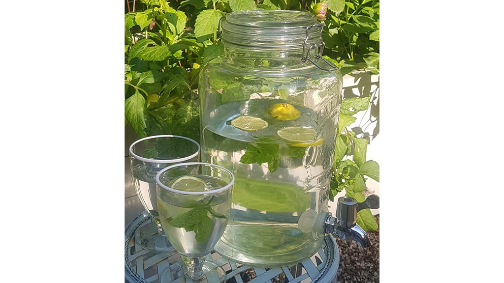 Vintage glass water dispensers with lemons inside.